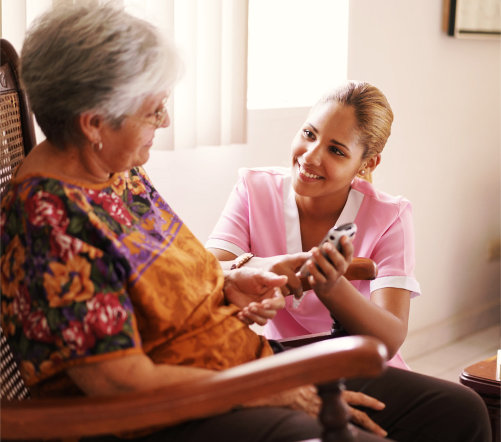 caregiver talking with a senior woman